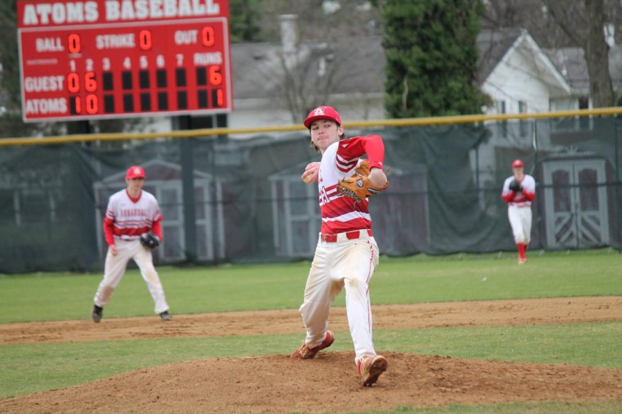Junior Evan Newton throws a fastball in the Atoms 10-1 loss against the Wolves. Newton pitched two innings, allowing two runs.