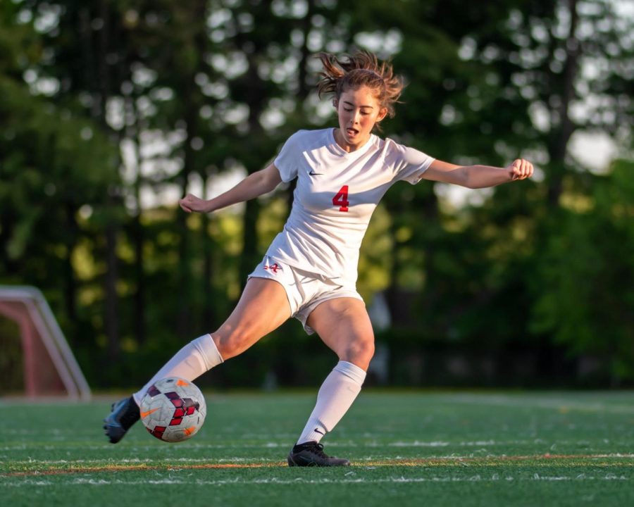 Junior Chelsi Lilli controls possession in the Atoms playoff game against Falls Church on May 16.