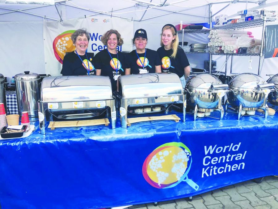 Meredith Hedrick (middle left) helps refugees at the distribution center alongside the volunteers she met through the World Central Kitchen