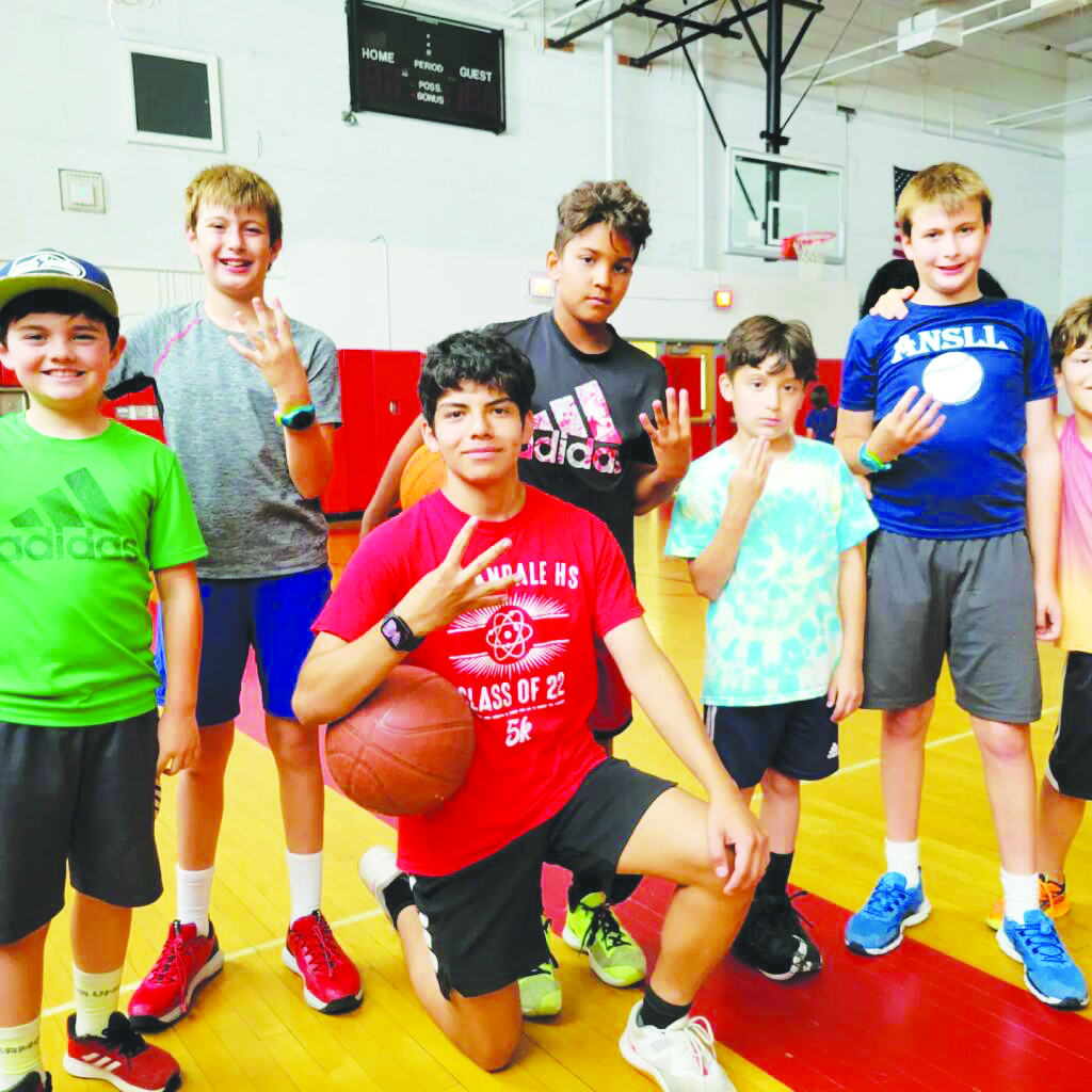 Sophomore Jaden Banos poses with his winning team at a sports camp in 2022.