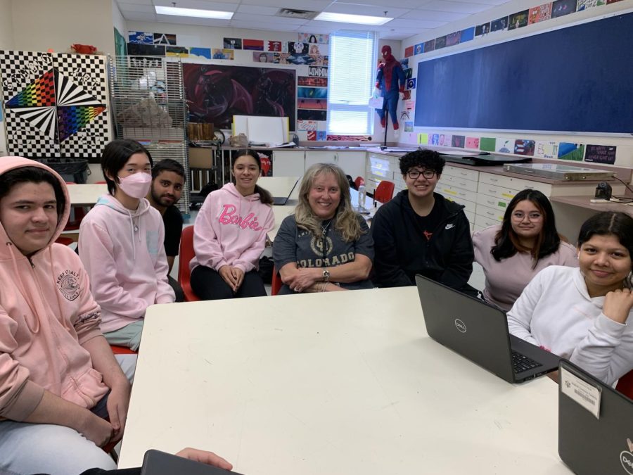 Studio art and design teacher Jacqueline Pappas poses with students as her last year comes to a close.