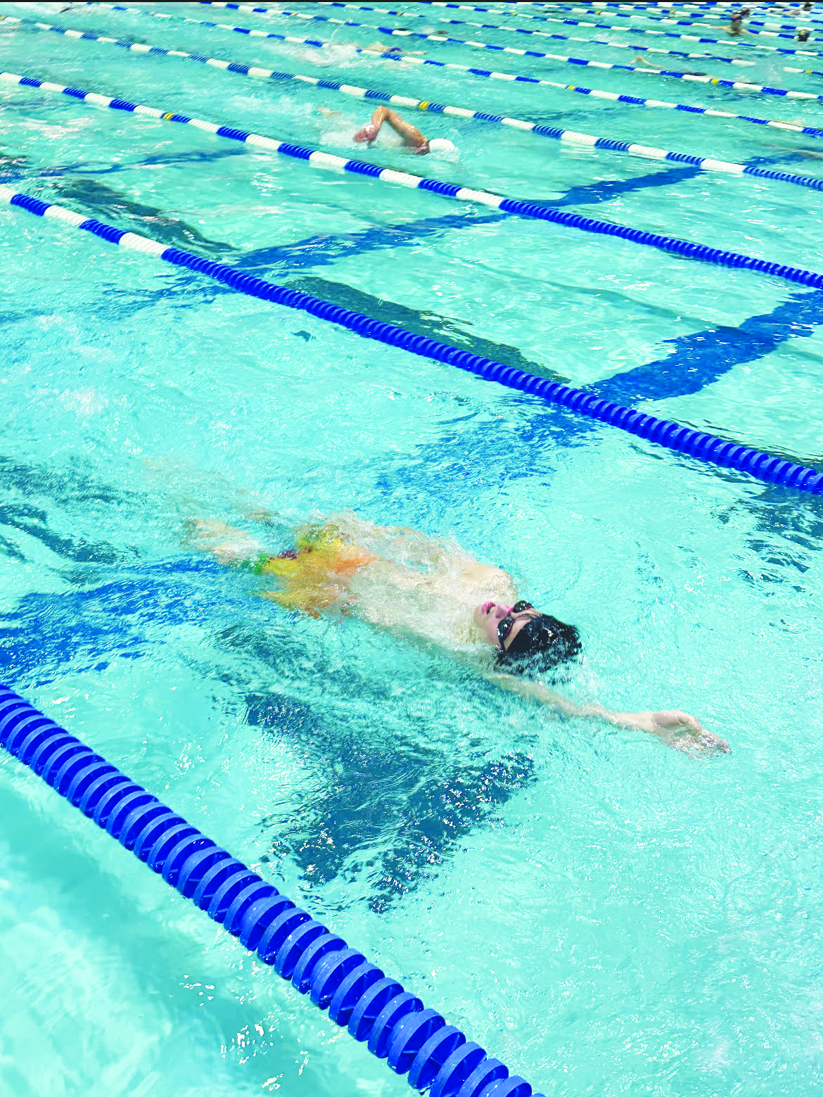 Dec. 7, Freshman Connor Uzokoff swims backstroke during practice.