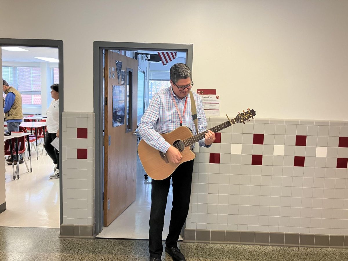 Henceroth Dayton plays his guitar in the math hallway during passing period. Dayton has played the guitar since he was a 12 years old and has joined various bands throughout his academic years.
