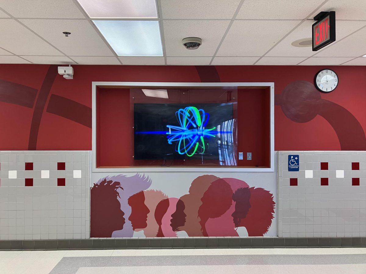 The new art mural displayed in the main hallway, drawn by a privately hired company portrays generic side profiles in flat color.