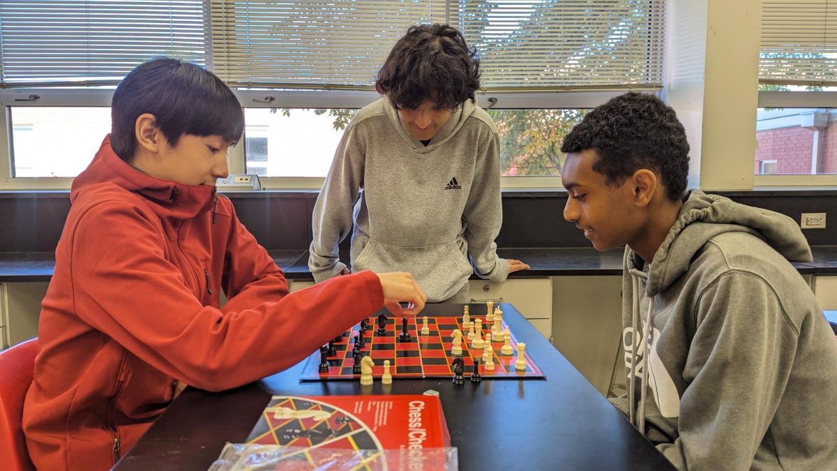 Above students compete in a game of chess during this years’ first Activities Day