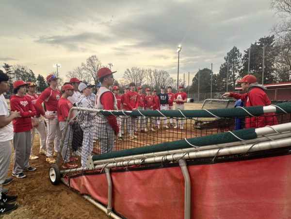 The Atoms baseball team huddled up around Head Coach Kevin Rudd to discuss field conditions for the upcoming season, 02/22
