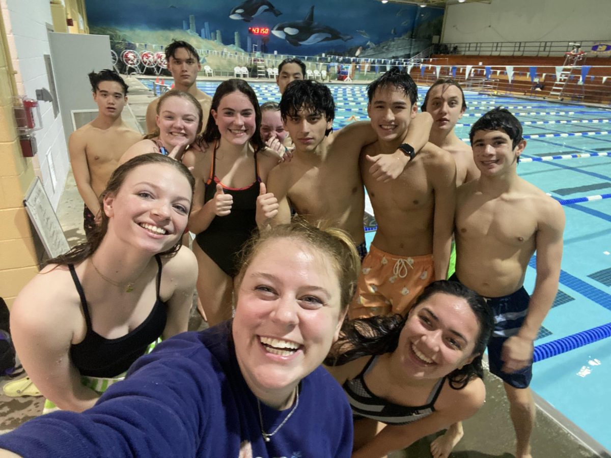 Atoms Head Coach Carmen Lucas poses for a photo with her team after practice