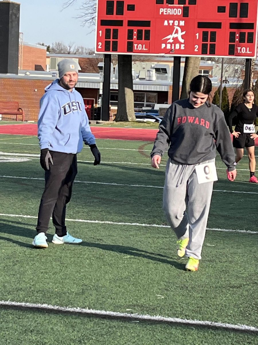 Sophomore Duha Haj-Assad hi-fives coach Jake Vaughns hand