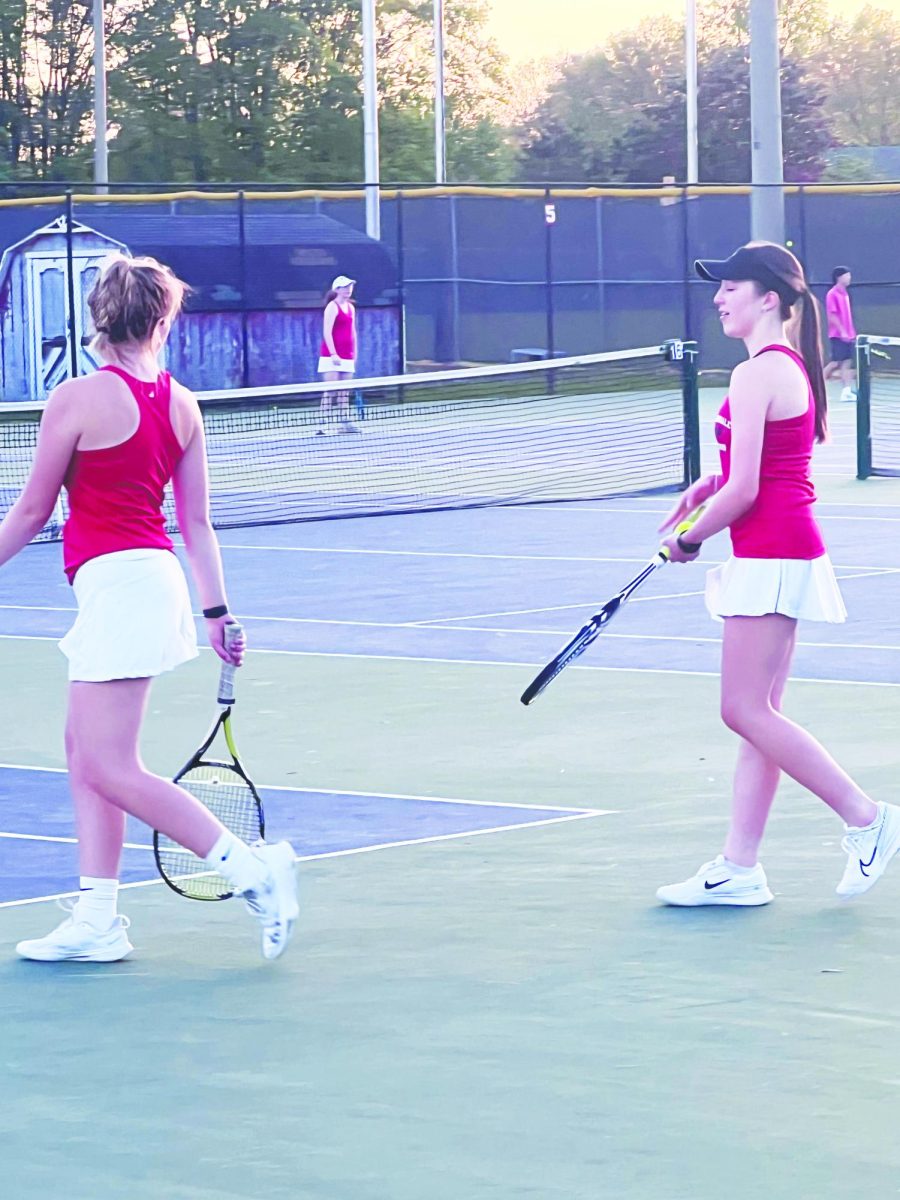 Sophomore Lizzie Gronberg (right) practicing her spring sport, tennis, with her teammate.