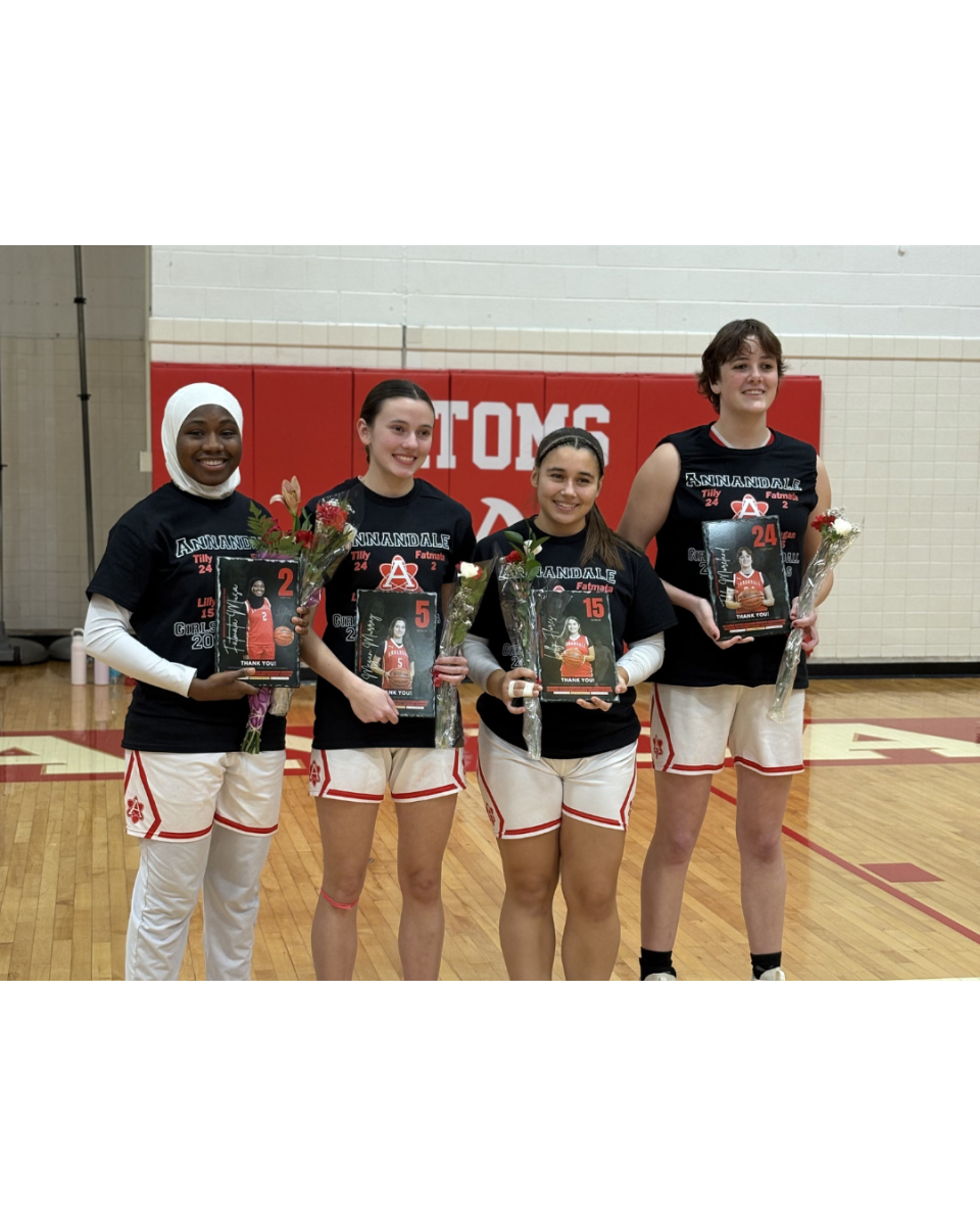 Seniors Fatmata Musa, Megan Murray, Lilly Flores and Matilda Moreland pose for a picture after receiving plaques made by their coaches.