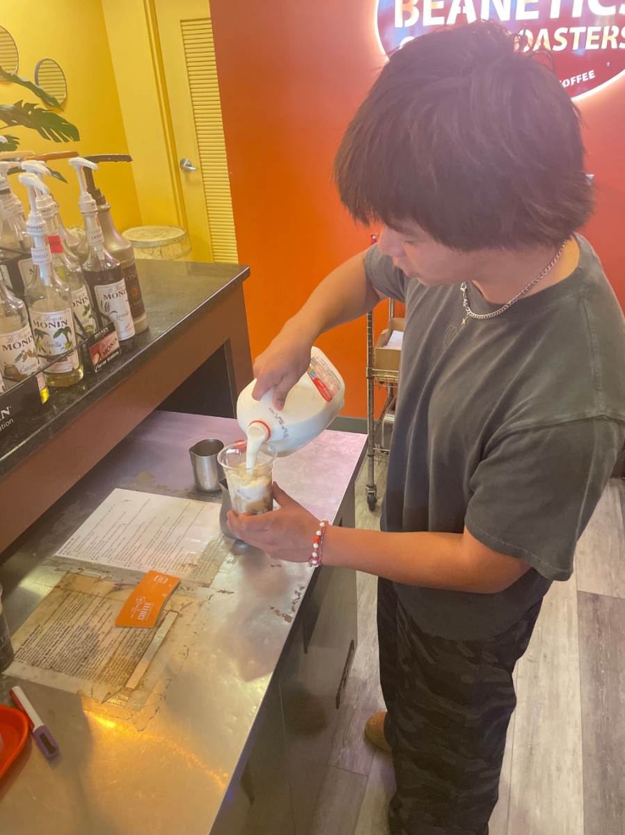 Junior Andrew Banks makes an iced coffee at Beanatics in Annandale.