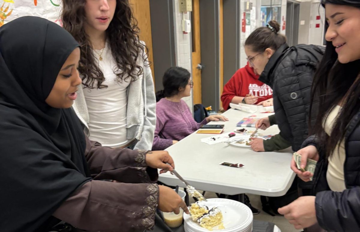 Junior Amira Omer serves up dessert for the Muslim Student Association’s stall at the Just World Festival, one of the opportunities groups can use to raise funds.