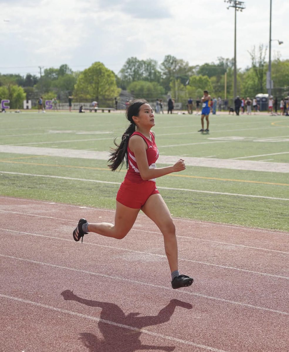 Zafar's teammate, sophomore Lena Nguyen runs the 400m race at Chantilly High School during a meet on April 26, 2025.