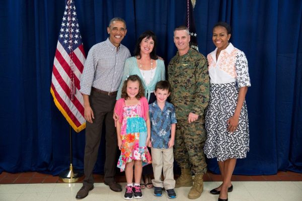 Timothy Mahoney, at eight years old, and his family take a priceless photo with President Obama and Michelle Obama.